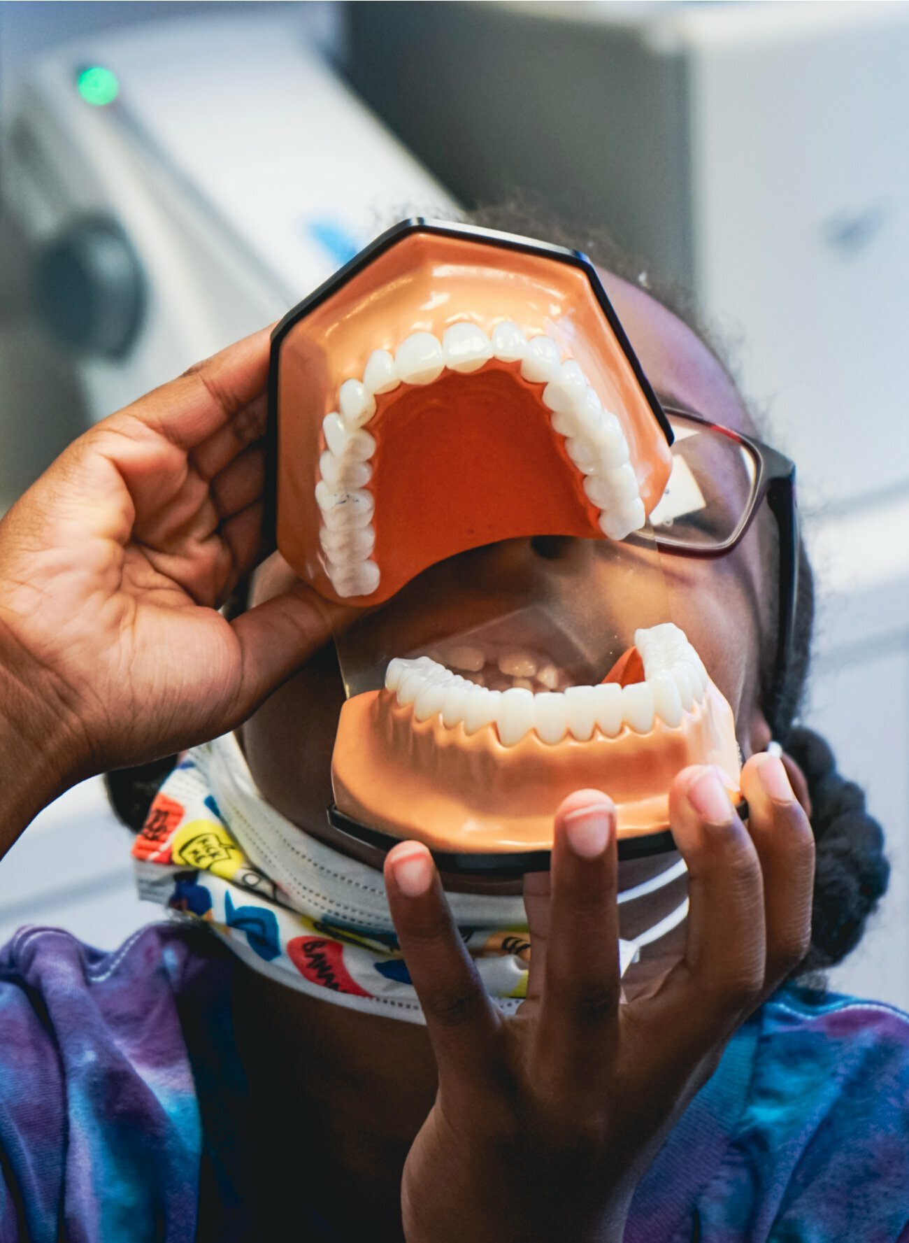Beverly Hills Cosmetic Dentistry child patient playing with tooth models