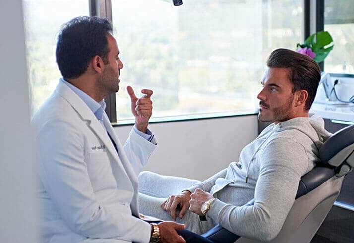 invisalign patient model consulting with cosmetic dentist dr raanan