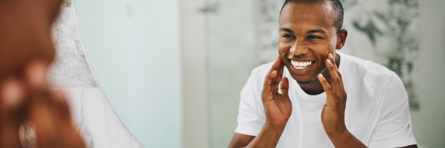 dental patient model looking in a mirror and smiling